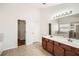 Bathroom featuring a double vanity with wood cabinets, tile flooring, and a large mirror at 379 Peachstone Way, Lawrenceville, GA 30043