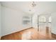 Bedroom featuring hardwood floors, a window and an elegant chandelier at 379 Peachstone Way, Lawrenceville, GA 30043