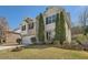Two-story home with brick accents, two car garage, landscaped yard, and mature trees at 379 Peachstone Way, Lawrenceville, GA 30043