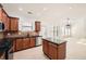 Kitchen features a center island with black countertops and modern stainless steel appliances at 379 Peachstone Way, Lawrenceville, GA 30043