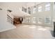 Bright, open-concept living room features a staircase, fireplace, and modern lighting at 379 Peachstone Way, Lawrenceville, GA 30043