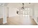 Open-concept living and dining area featuring hardwood floors, arched doorways and lots of natural light at 379 Peachstone Way, Lawrenceville, GA 30043