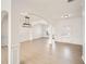 Open-concept living area with hardwood floors, decorative columns, and modern light fixture at 379 Peachstone Way, Lawrenceville, GA 30043