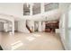 Expansive open concept living area featuring staircase, fireplace, light-colored walls and floors, and modern lighting at 379 Peachstone Way, Lawrenceville, GA 30043