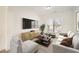 Bright living room with a large window, modern furniture, and sleek media console at 379 Peachstone Way, Lawrenceville, GA 30043