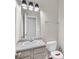 Well-lit bathroom features a vanity with a sink, a mirror, and a toilet for comfortable use at 4720 Buffalo St, Fairburn, GA 30213