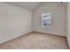 Bright bedroom featuring vaulted ceilings, a window with blinds, and neutral carpeting for a cozy feel at 4720 Buffalo St, Fairburn, GA 30213