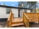 Charming back porch with wood railings and steps for outdoor enjoyment at 4739 Cook Sw Rd, Stockbridge, GA 30281