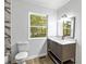 Modern bathroom with a stylish vanity, marble accents, and a large window offering a view of the outdoors at 4739 Cook Sw Rd, Stockbridge, GA 30281
