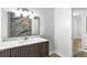 Sleek bathroom featuring a marble-tiled shower and a modern vanity with a marble countertop and large mirror at 4739 Cook Sw Rd, Stockbridge, GA 30281