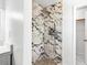 Bathroom featuring a walk-in shower with decorative marble tile and a modern shower head at 4739 Cook Sw Rd, Stockbridge, GA 30281