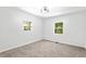 Bedroom featuring neutral carpet, white walls, modern light fixture and two windows providing natural light at 4739 Cook Sw Rd, Stockbridge, GA 30281