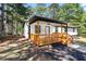 Charming home with a covered porch featuring wood railings, offering a welcoming outdoor space and curb appeal at 4739 Cook Sw Rd, Stockbridge, GA 30281