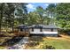 A charming house with a cozy front porch and a blend of modern renovation and classic comfort amid mature trees at 4739 Cook Sw Rd, Stockbridge, GA 30281