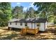 Exterior of a home with a wooden deck, windows, and a yard with trees at 4739 Cook Sw Rd, Stockbridge, GA 30281