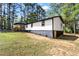 A charming side-view of the house showcasing manicured landscaping, and a glimpse of its updated exterior at 4739 Cook Sw Rd, Stockbridge, GA 30281