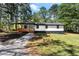 Charming renovated ranch-style home with a cozy front porch and well-maintained front yard surrounded by mature trees at 4739 Cook Sw Rd, Stockbridge, GA 30281