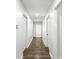 Hallway with modern flooring and neutral paint, connecting rooms and leading to the attic access point at 4739 Cook Sw Rd, Stockbridge, GA 30281
