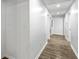 Hallway features modern wood-look floors and white walls connecting rooms and leading towards the attic access at 4739 Cook Sw Rd, Stockbridge, GA 30281