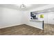 Open-concept living and dining room with wood-look tile flooring flowing into the kitchen area with white countertops at 4739 Cook Sw Rd, Stockbridge, GA 30281