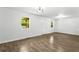 Bright living room features wood-look flooring, white walls, updated lighting, and natural light from the windows at 4739 Cook Sw Rd, Stockbridge, GA 30281