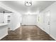 Bright living room featuring tile flooring, a modern light fixture, and neutral paint, creating a warm atmosphere at 4739 Cook Sw Rd, Stockbridge, GA 30281