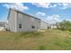 Backyard view of a two story house with a grassy lawn and a concrete patio at 4825 Layton Drive, Lithia Springs, GA 30122