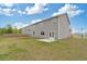 The backyard of this home features a spacious lawn area and a small concrete patio at 4825 Layton Drive, Lithia Springs, GA 30122