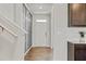 Hallway featuring wood-look floors, a storage accent wall, and a view of the home's entry door at 4825 Layton Drive, Lithia Springs, GA 30122