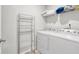 Laundry room includes a washer, dryer, wire shelving, and neutral paint at 4825 Layton Drive, Lithia Springs, GA 30122