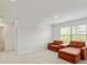 Bonus room with neutral carpet, orange lounge chairs, and lots of natural light at 4825 Layton Drive, Lithia Springs, GA 30122