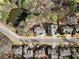 Aerial view of the property, showcasing the neighborhood and a serene pond at 1351 Ashbury Park Dr, Hoschton, GA 30548