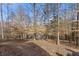 Expansive backyard with mature trees provides privacy and shade, offering a serene natural setting at 1351 Ashbury Park Dr, Hoschton, GA 30548
