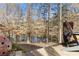 Inviting backyard deck with wooded lake view creates a peaceful outdoor space at 1351 Ashbury Park Dr, Hoschton, GA 30548