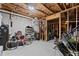 Unfinished basement with exposed beams and exercise equipment at 1351 Ashbury Park Dr, Hoschton, GA 30548