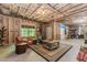 Unfinished basement living space with rustic wooden accents, including a coffee table and a wine rack at 1351 Ashbury Park Dr, Hoschton, GA 30548