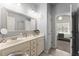 Elegant bathroom with double sinks, a large mirror, and updated lighting, offering a luxurious and functional space at 1351 Ashbury Park Dr, Hoschton, GA 30548
