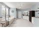 Large bathroom featuring a luxurious bathtub, walk-in shower, granite counters, and natural light at 1351 Ashbury Park Dr, Hoschton, GA 30548