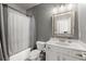 Bathroom features a vanity with a large mirror, updated fixtures, and a shower-tub combination at 1351 Ashbury Park Dr, Hoschton, GA 30548