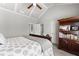 Bedroom with neutral color scheme, tray ceiling, ceiling fan, dresser, and view to ensuite bathroom at 1351 Ashbury Park Dr, Hoschton, GA 30548