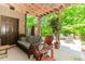 Relaxing covered patio featuring comfortable seating and natural wood accents at 1351 Ashbury Park Dr, Hoschton, GA 30548