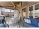 Inviting screened-in porch with ceiling fan, comfortable seating, and views of backyard at 1351 Ashbury Park Dr, Hoschton, GA 30548