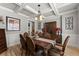Elegant dining room featuring coffered ceilings, hardwood floors, and a stylish buffet at 1351 Ashbury Park Dr, Hoschton, GA 30548