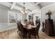 Bright dining room boasting coffered ceilings, hardwood floors, and elegant decor at 1351 Ashbury Park Dr, Hoschton, GA 30548