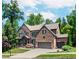 Beautiful two-story brick home featuring a landscaped lawn and a three-car garage at 1351 Ashbury Park Dr, Hoschton, GA 30548