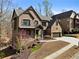 Charming two-story brick home featuring a well-manicured front yard and a two-car garage at 1351 Ashbury Park Dr, Hoschton, GA 30548