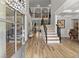 Grand foyer with hardwood floors, high ceilings, and a staircase leading to the upper level at 1351 Ashbury Park Dr, Hoschton, GA 30548