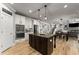 Open kitchen with an island, double oven, and stainless steel appliances at 1351 Ashbury Park Dr, Hoschton, GA 30548