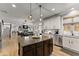 Open kitchen with stainless appliances connects to the dining and living areas at 1351 Ashbury Park Dr, Hoschton, GA 30548