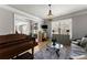 Comfortable living room with hardwood floors, an upright piano, and a glass-topped coffee table at 1351 Ashbury Park Dr, Hoschton, GA 30548